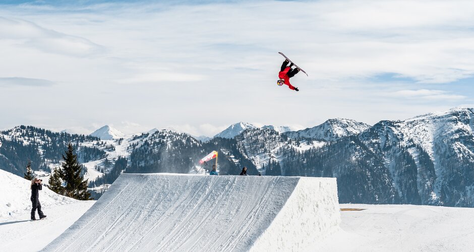 Freestyler time trick with the snowboard at the large jump on the Shuttle Mountain 