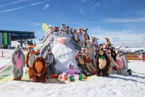 Group of skiers in Easter bunny costumes posing on snowy hill in sunny weather at ski resort area | © Shuttleberg