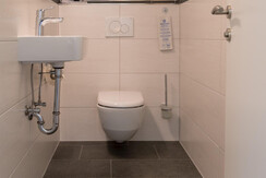 Toilet in the studio separate from the bathroom