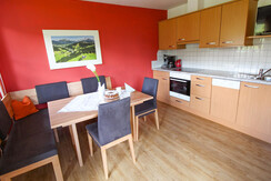 Bright and friendly living room with dining area and kitchen