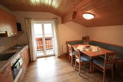 Kitchen-cum-living room with dining area, kitchenette and balcony