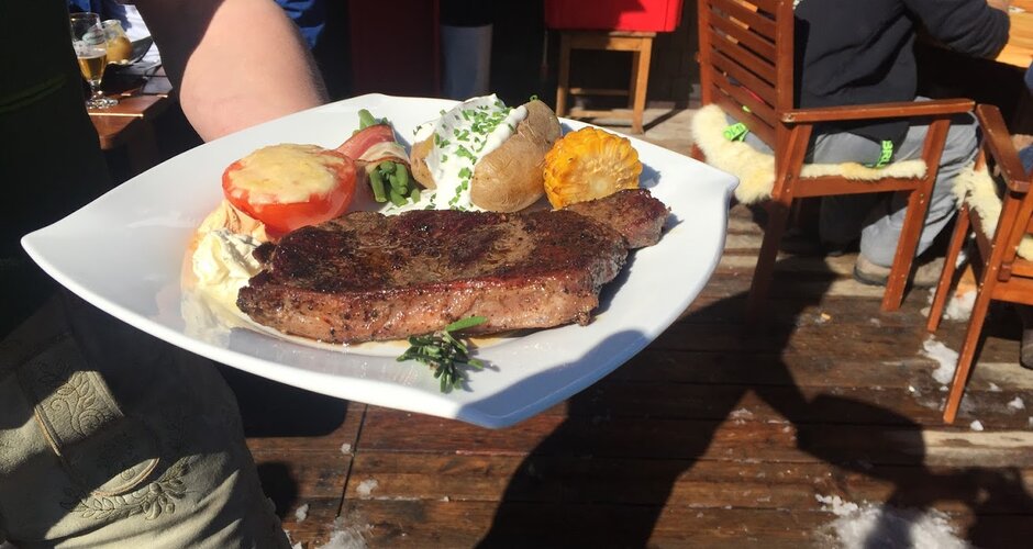 Fertiges Essen mit Fleisch, Ofenkartoffel und Gemüse wird serviert. | © Hauser Kaibling