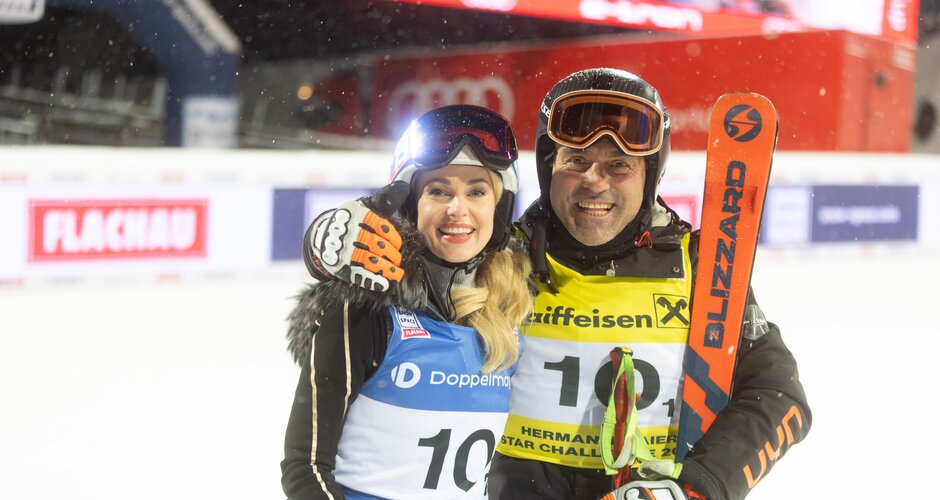 Silvia Schneider and Kristian Ghedina smiling in finish area with ski gear | © Snow Space Salzburg / Wildbild