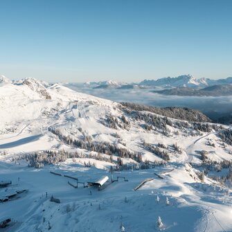 Shuttleberg ski area with lifts, slopes, snowy hills, forest and mountain panorama | © Shuttleberg