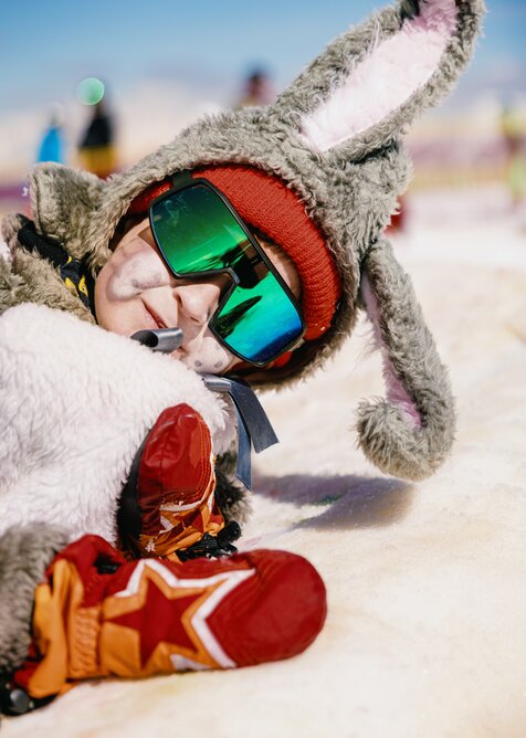 A child is seen dressed as a rabbit and wearing large sunglasses | © Markus Rohrbacher