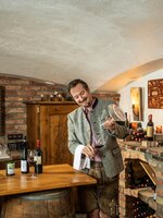 Wine tasting at Tirolerhof Flachau with host in wine cellar